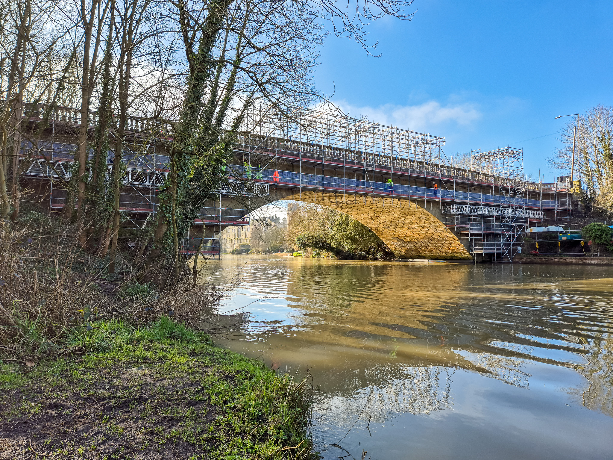 Elevation view of a cantilever droplift scaffold over a river.