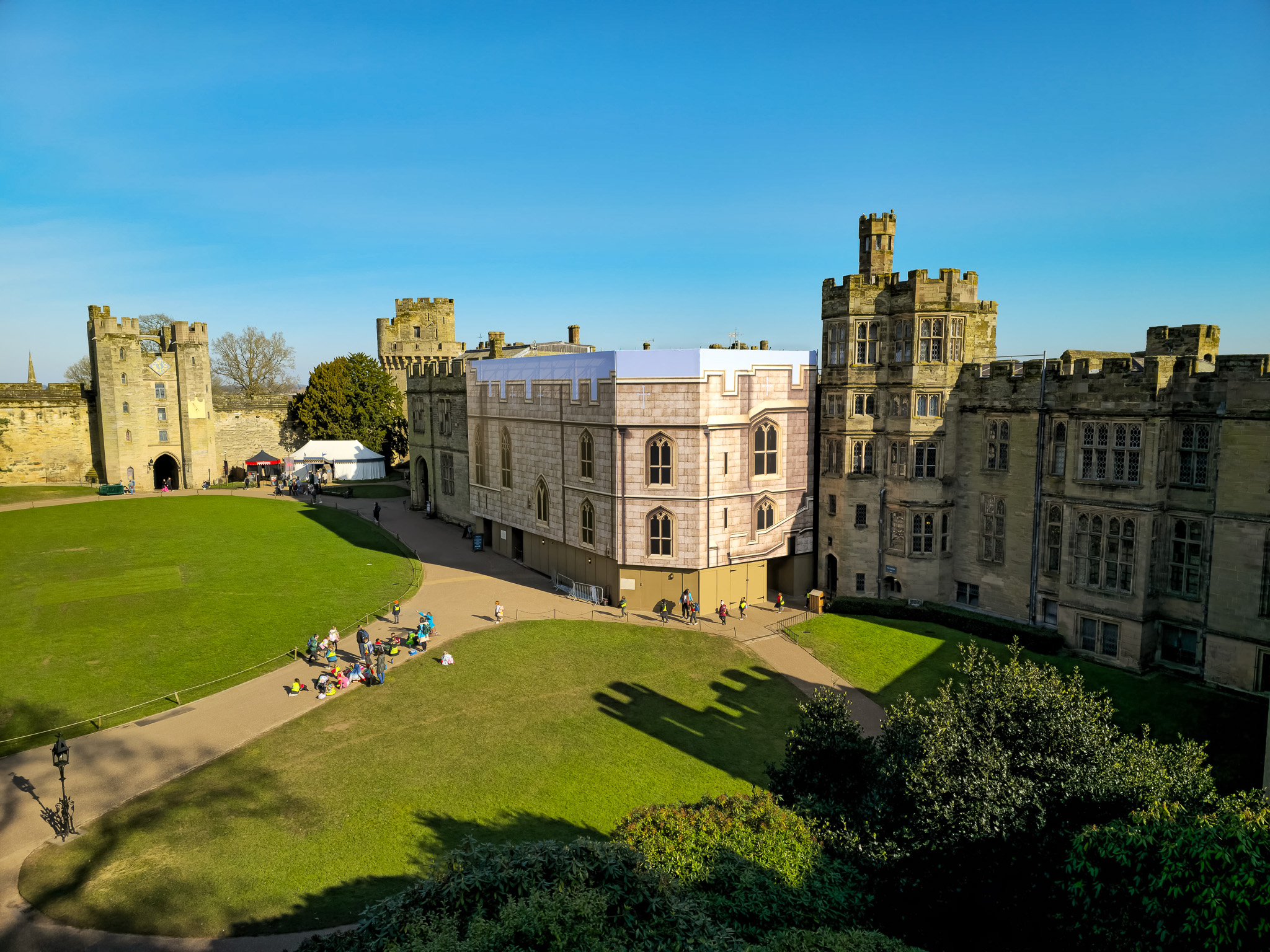 Freestanding scaffold on heritage site with a full scaffold wrap depicting a castle